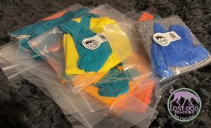 Photo of a pile of ziplock bags to create a scent item, with brightly coloured cloths and latex gloves.